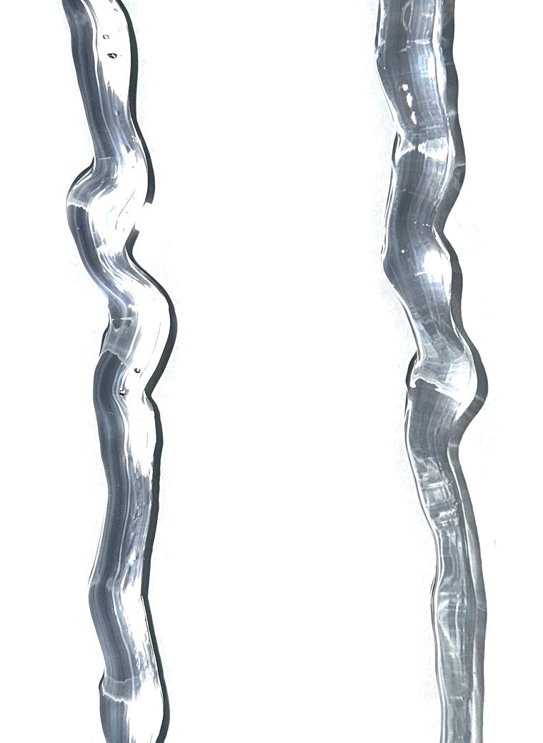 Two beads of Newborn Crystal Clear sealant on a white ground, colourless and glossy