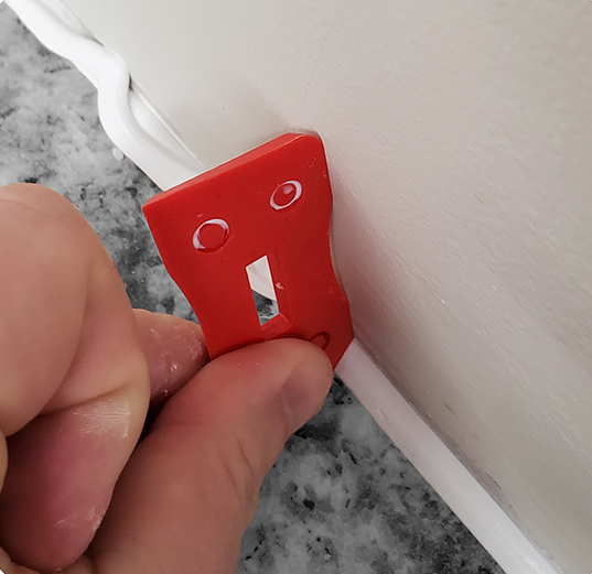 Tooling square in use caulking a joint.